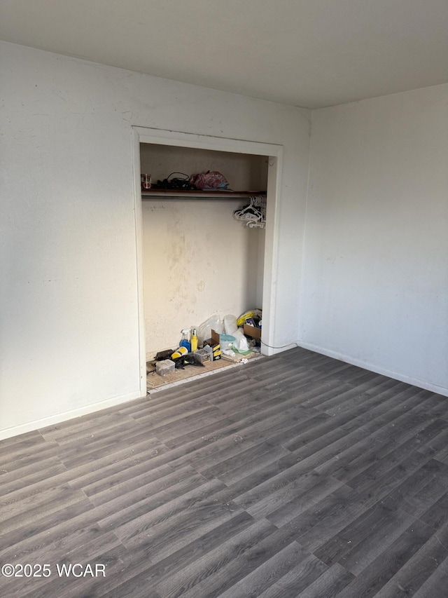 unfurnished bedroom featuring wood finished floors and baseboards
