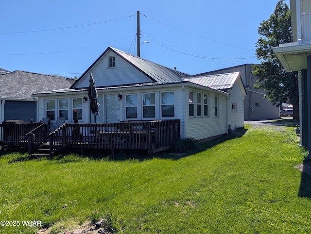 127 Brads Way, Russells Point, OH 43348 - view of front of house with a wooden deck, a front lawn, and metal roof