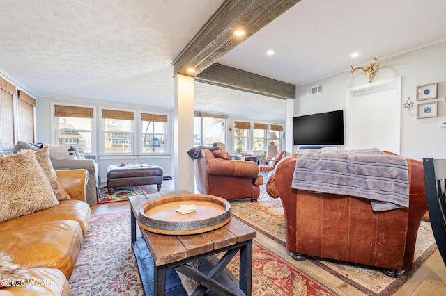 127 Brads Way, Russells Point, OH 43348 - living room with light wood-type flooring, healthy amount of natural light, a textured ceiling, beamed ceiling, and recessed lighting