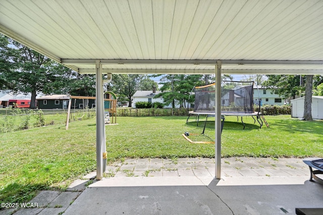 2238 N Glenwood Ave, Lima, OH 45805 - fenced backyard featuring a trampoline, a patio area, and a storage shed
