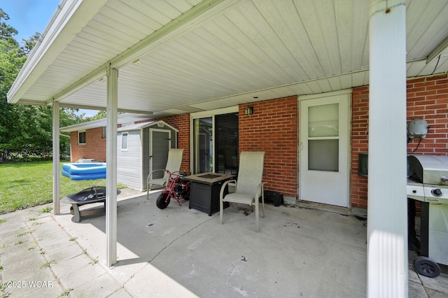 2238 N Glenwood Ave, Lima, OH 45805 - view of patio featuring an outdoor fire pit and a shed