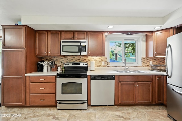 2238 N Glenwood Ave, Lima, OH 45805 - kitchen featuring appliances with stainless steel finishes, light countertops, decorative backsplash, and recessed lighting