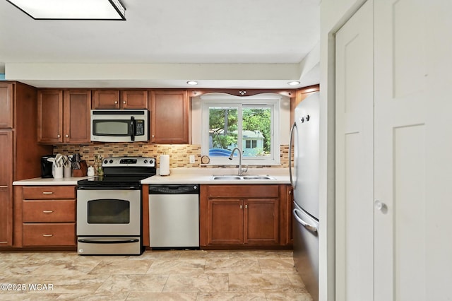 2238 N Glenwood Ave, Lima, OH 45805 - kitchen with stainless steel appliances, light countertops, tasteful backsplash, and brown cabinetry