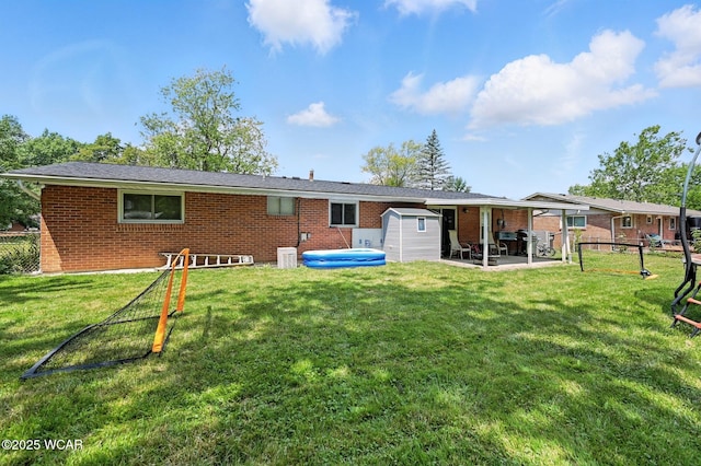 2238 N Glenwood Ave, Lima, OH 45805 - back of house with brick siding, a storage shed, and a patio area