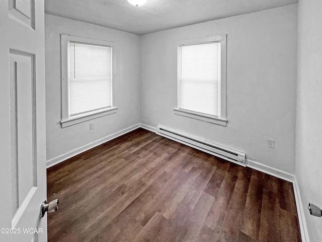 556 Cortlandt Ave, Lima, OH 45801 - empty room with a baseboard radiator and dark wood finished floors