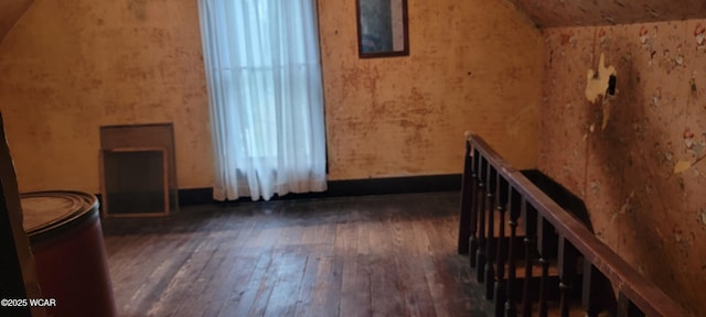 additional living space with lofted ceiling and dark wood-type flooring