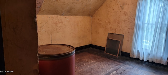 interior space with dark hardwood / wood-style floors and vaulted ceiling