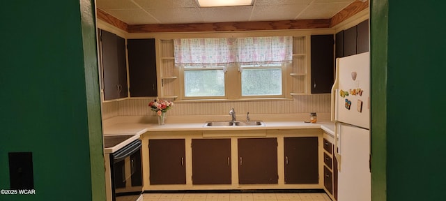 kitchen with white appliances, a paneled ceiling, and sink