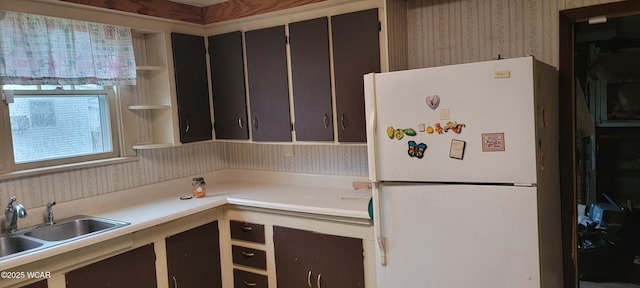 kitchen with sink and white fridge