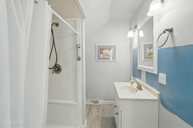 510 N Walnut St, Van Wert, OH 45891 - full bathroom with vanity, a shower with shower curtain, wood finished floors, and lofted ceiling