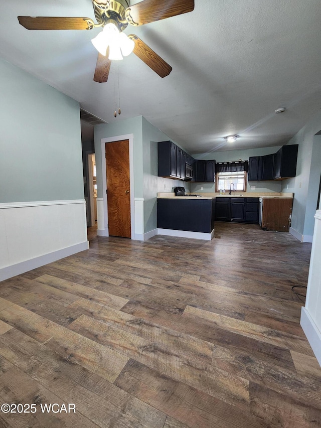 kitchen with dark hardwood / wood-style flooring, sink, vaulted ceiling, and a textured ceiling