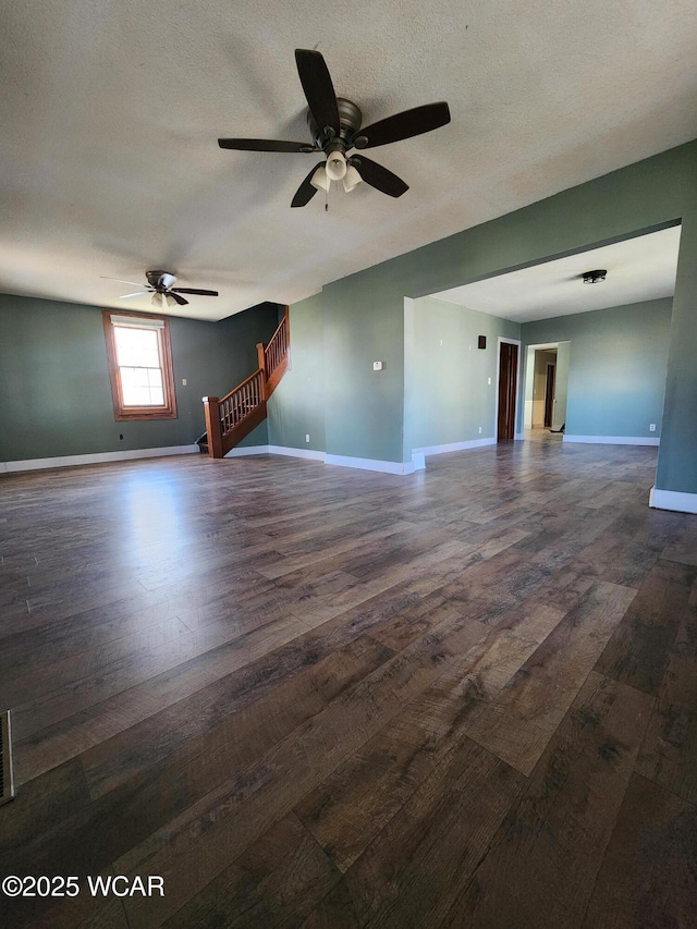 empty room featuring ceiling fan, dark hardwood / wood-style floors, and a textured ceiling