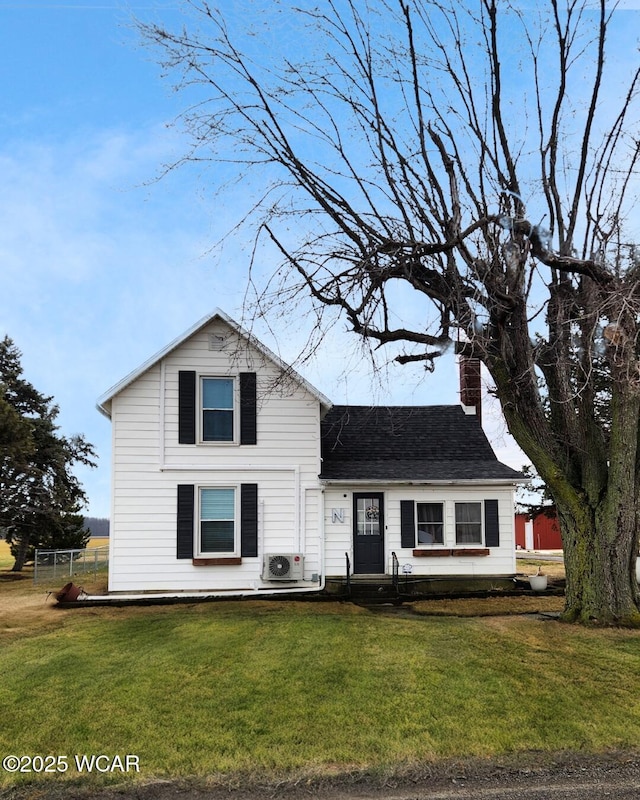 traditional-style home with a front lawn, a chimney, a shingled roof, and ac unit