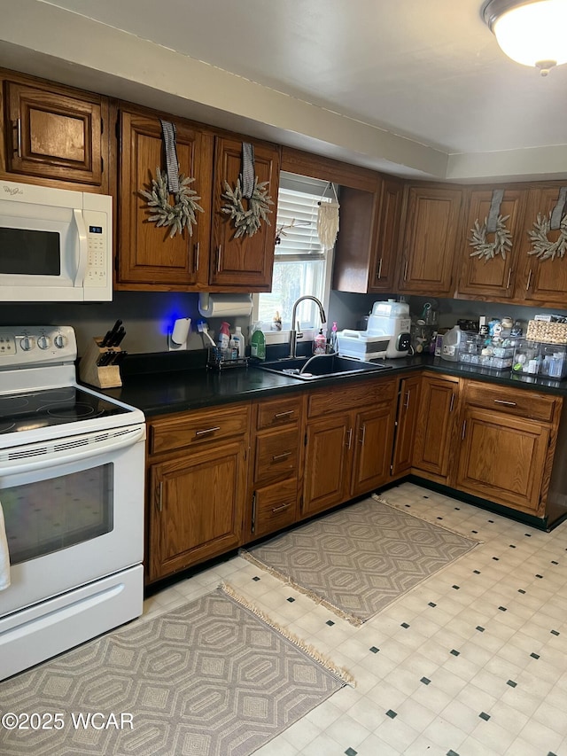 kitchen featuring sink and white appliances