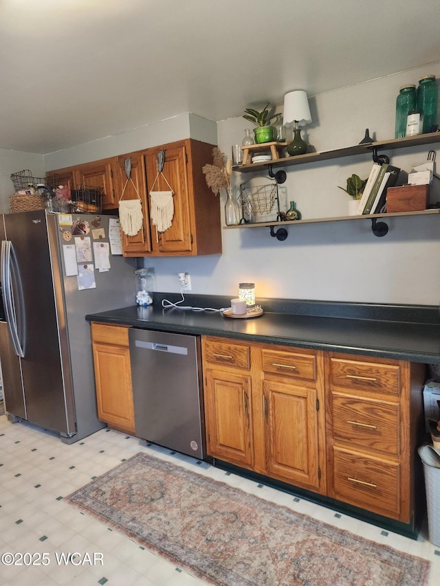 kitchen featuring appliances with stainless steel finishes, brown cabinetry, and open shelves