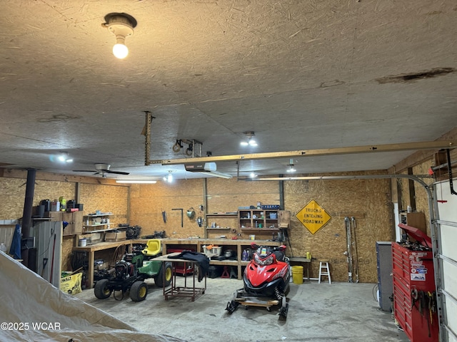 garage featuring a garage door opener and a workshop area