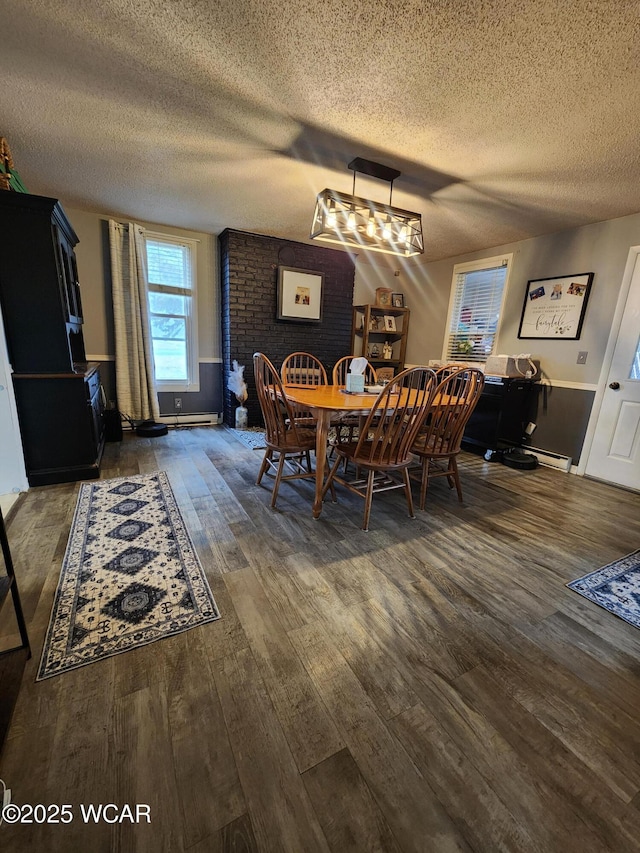 dining area featuring a textured ceiling and wood finished floors