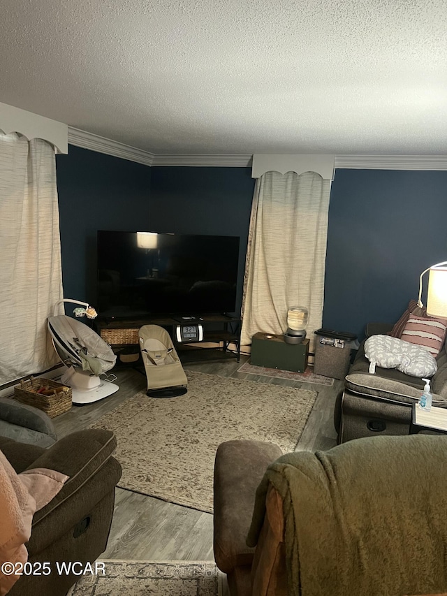 living room featuring crown molding, hardwood / wood-style floors, and a textured ceiling