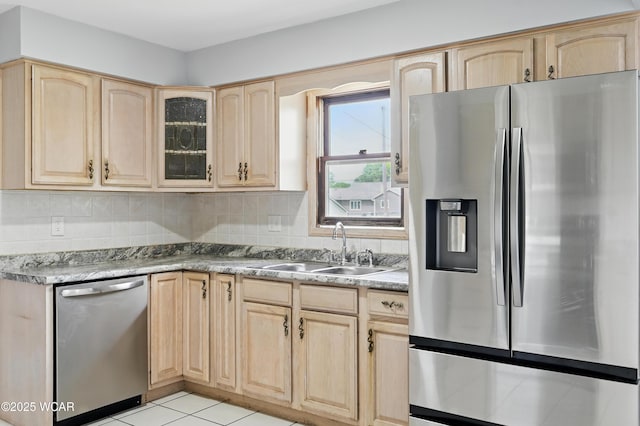 4836 Willow St, Lima, OH 45807 - kitchen featuring appliances with stainless steel finishes, light brown cabinets, a sink, glass insert cabinets, and tasteful backsplash