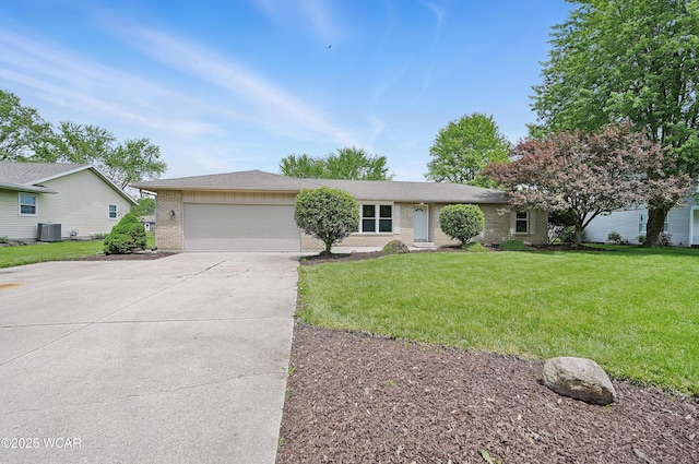 4836 Willow St, Lima, OH 45807 - single story home featuring brick siding, concrete driveway, an attached garage, central air condition unit, and a front yard