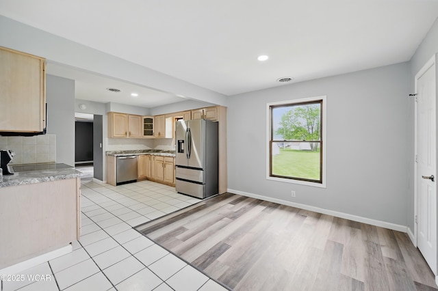 4836 Willow St, Lima, OH 45807 - kitchen featuring appliances with stainless steel finishes, light brown cabinets, glass insert cabinets, recessed lighting, and light wood-style floors