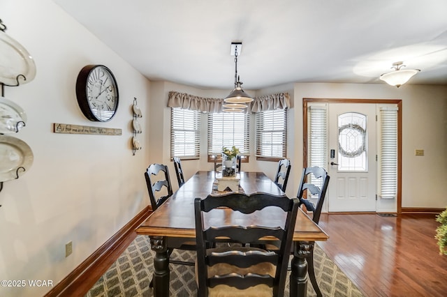 dining space with wood-type flooring