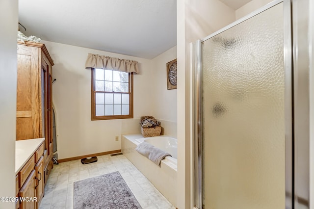 bathroom featuring vanity and shower with separate bathtub