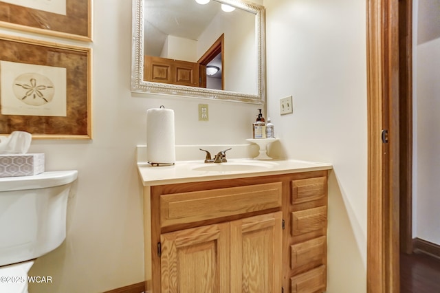 bathroom featuring vanity and toilet