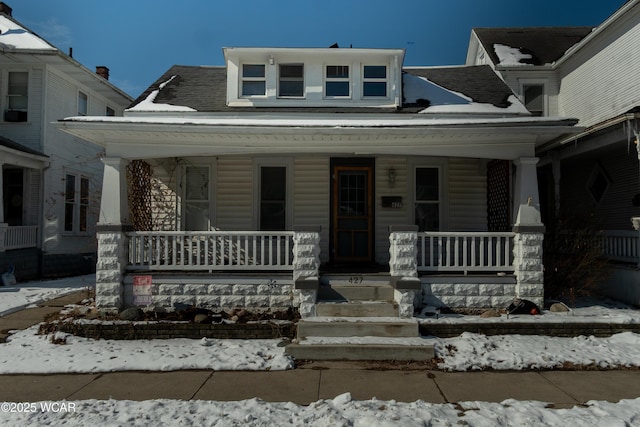 view of front of house featuring a porch and roof with shingles