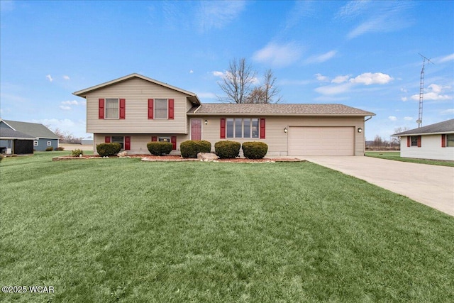 tri-level home with a garage, a front lawn, and concrete driveway