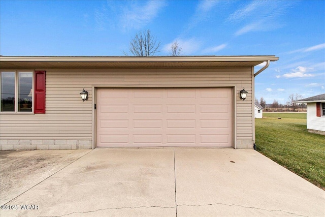 garage featuring concrete driveway