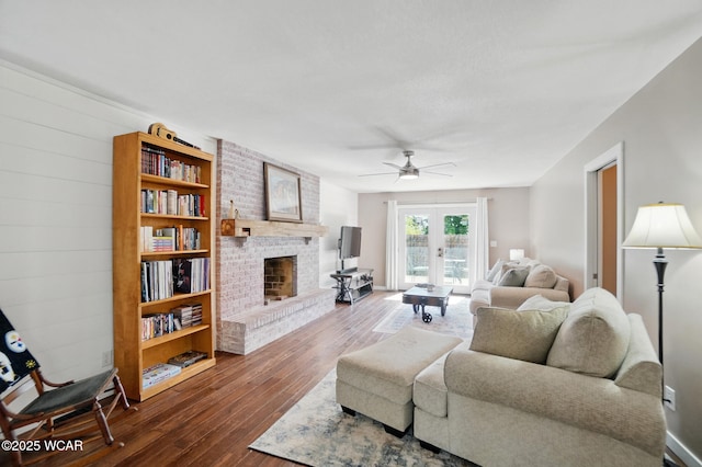 2715 Goldenrod Ln, Findlay, OH 45840 - living room featuring a brick fireplace, dark wood-style floors, ceiling fan, and french doors