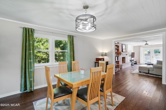 2715 Goldenrod Ln, Findlay, OH 45840 - dining space with a large fireplace, hardwood / wood-style flooring, a ceiling fan, baseboards, and a chandelier