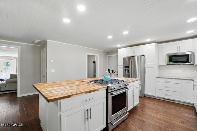 2715 Goldenrod Ln, Findlay, OH 45840 - kitchen with stainless steel appliances, wooden counters, recessed lighting, ornamental molding, and white cabinetry