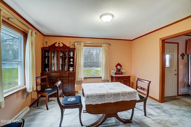 carpeted dining space featuring ornamental molding