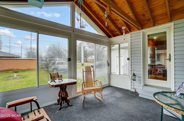 sunroom / solarium with wood ceiling, plenty of natural light, and lofted ceiling with beams