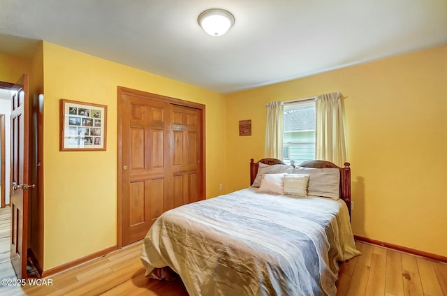 bedroom featuring light hardwood / wood-style floors and a closet