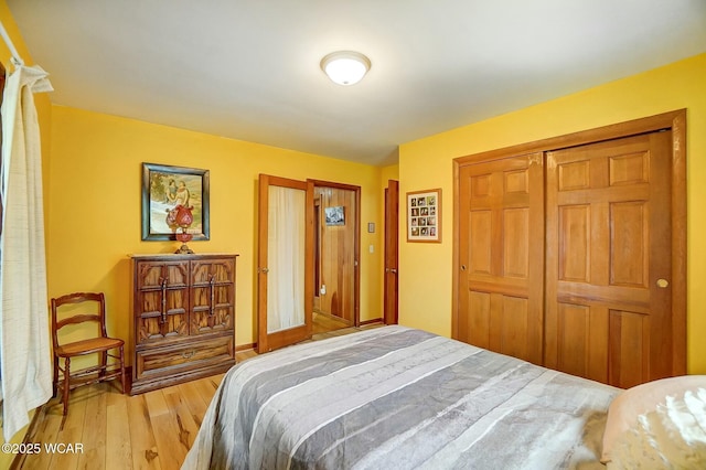 bedroom featuring a closet and light hardwood / wood-style flooring