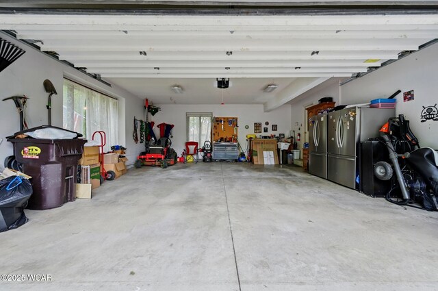 2979 Sands Rd, Lima, OH 45805 - garage featuring freestanding refrigerator and a garage door opener