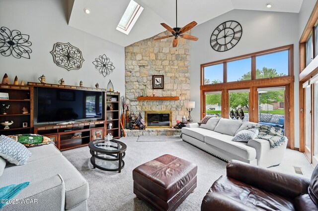 2979 Sands Rd, Lima, OH 45805 - carpeted living area with high vaulted ceiling, a skylight, ceiling fan, a fireplace, and recessed lighting