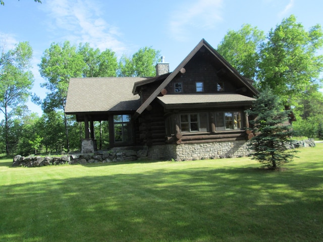 log home featuring a front lawn and a chimney