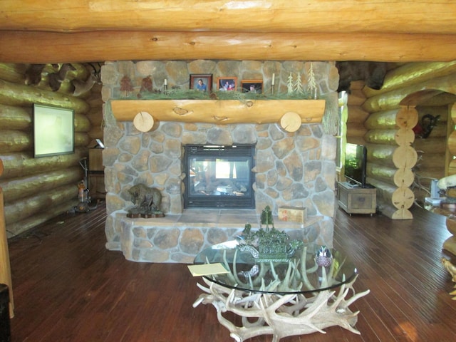 details with rustic walls, a stone fireplace, and wood finished floors