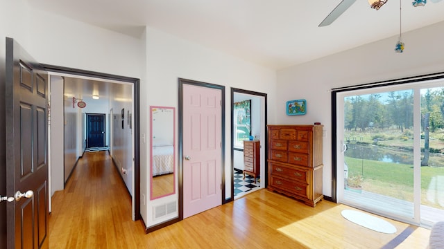 unfurnished bedroom featuring light wood-type flooring, ceiling fan, and access to outside