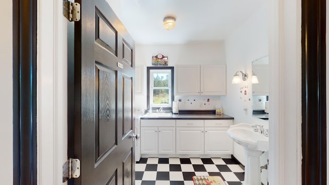 bathroom featuring tile patterned floors and a sink