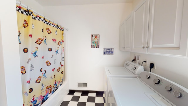 clothes washing area with tile patterned floors, visible vents, cabinet space, and washing machine and dryer