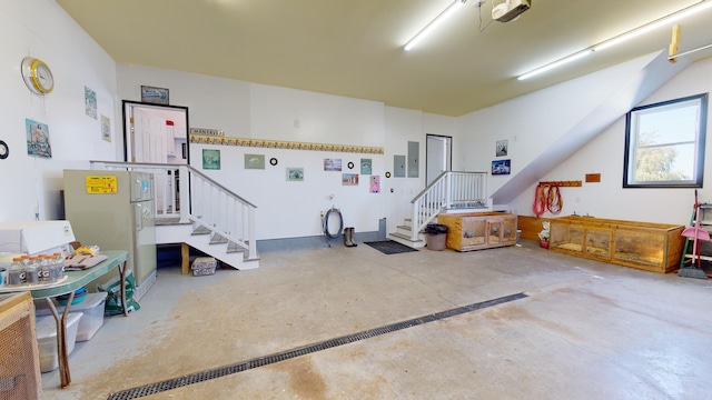 garage featuring electric panel and freestanding refrigerator