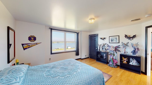 bedroom with visible vents and light wood-style floors