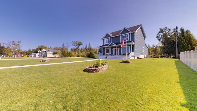 view of front of property featuring a front lawn and fence