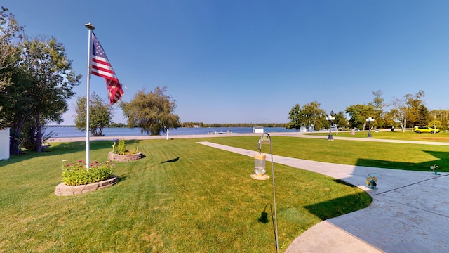 view of home's community with a yard and a water view