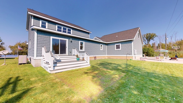 back of house featuring a lawn, central AC, and a patio